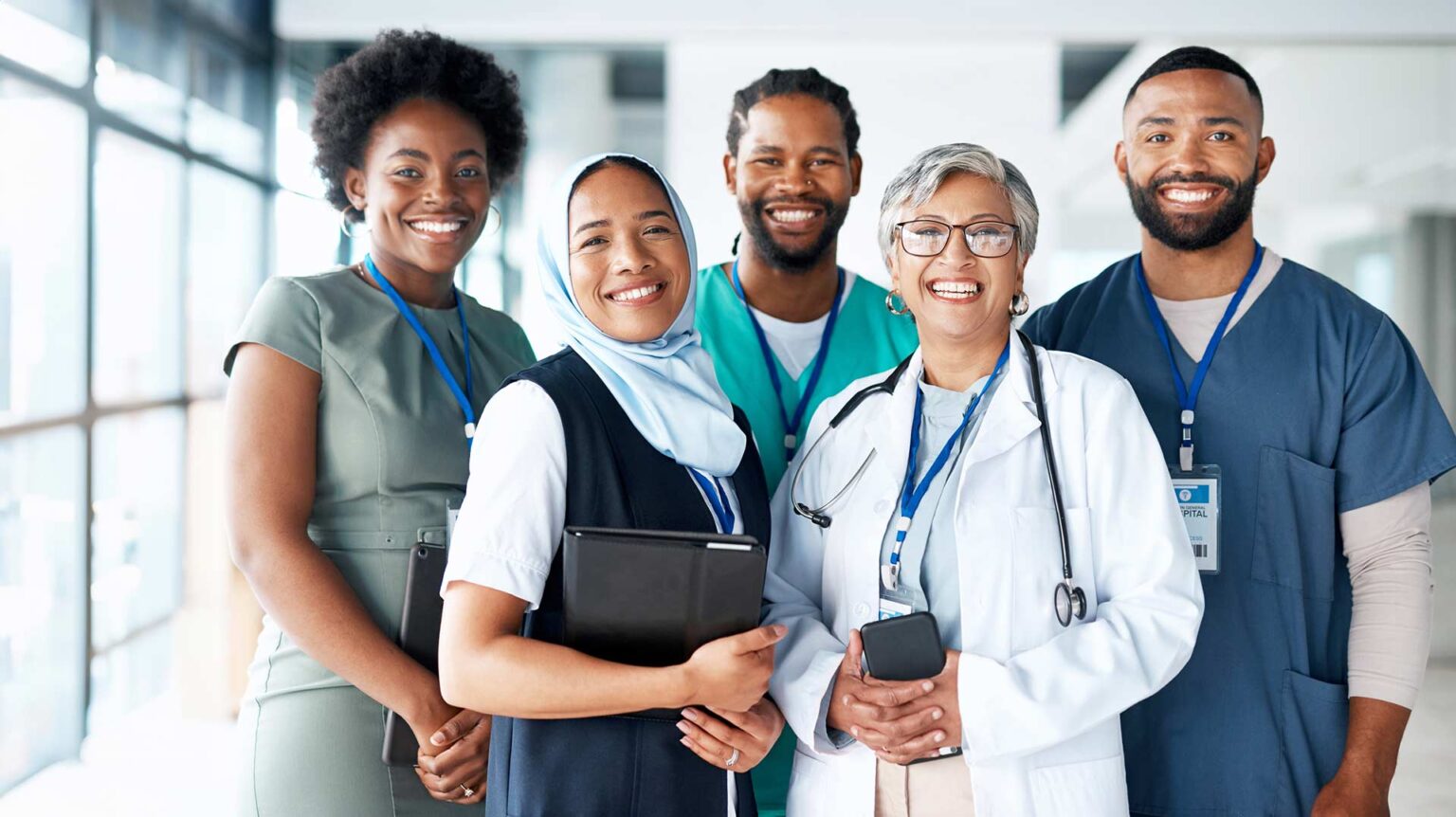A group of smiling nurses and a doctor.