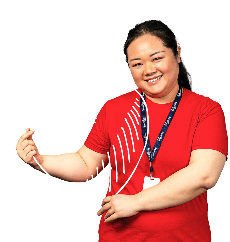 Spectrum Nurse smiling while holding a heart illustration.
